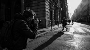 Photographer capturing a black and white urban street scene