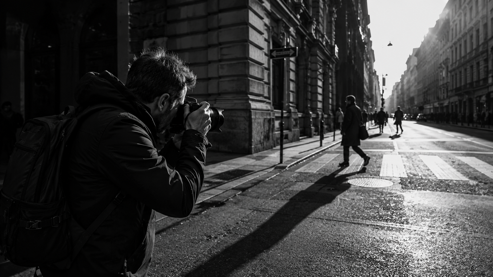 Photographer capturing a black and white urban street scene